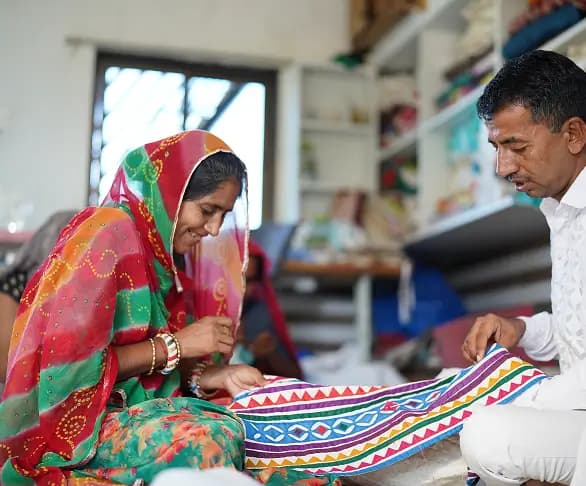 Artisan working on embroidery in a workshop