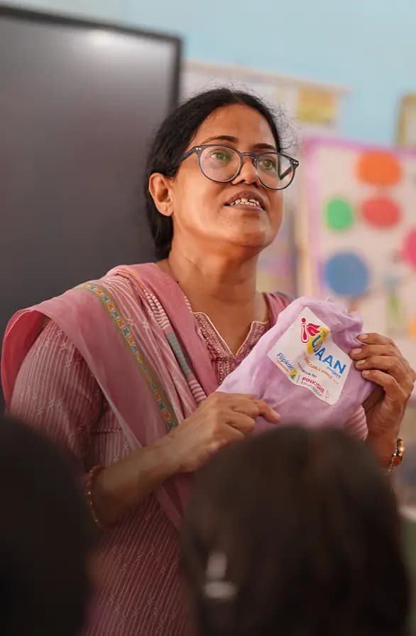 Woman holding a welfare scheme kit