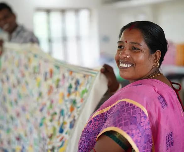 Woman displaying a handwoven textile