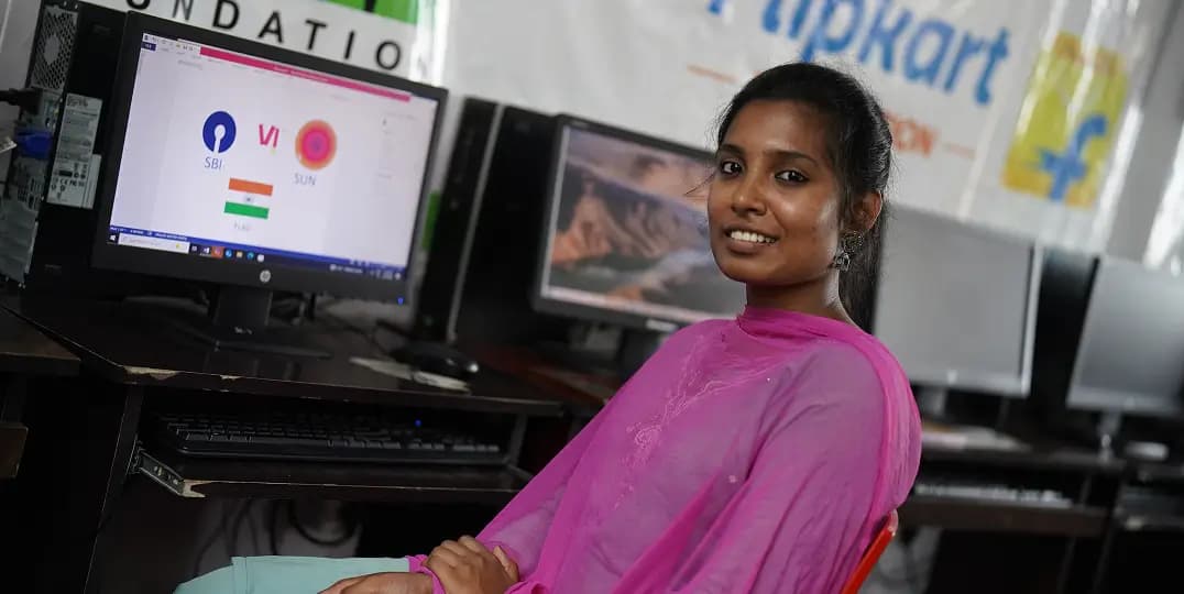 Woman works at computer station, Flipkart Foundation center